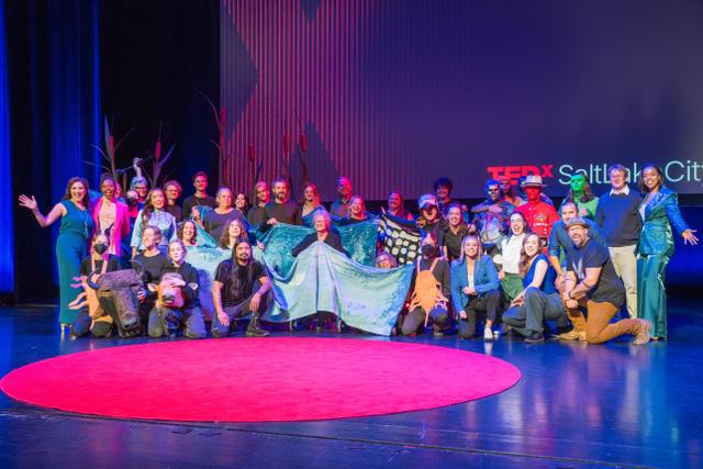 The/Theys with the TEDxSaltLakeCity speakers, performers and crew on the stage at the Capitol Theatre